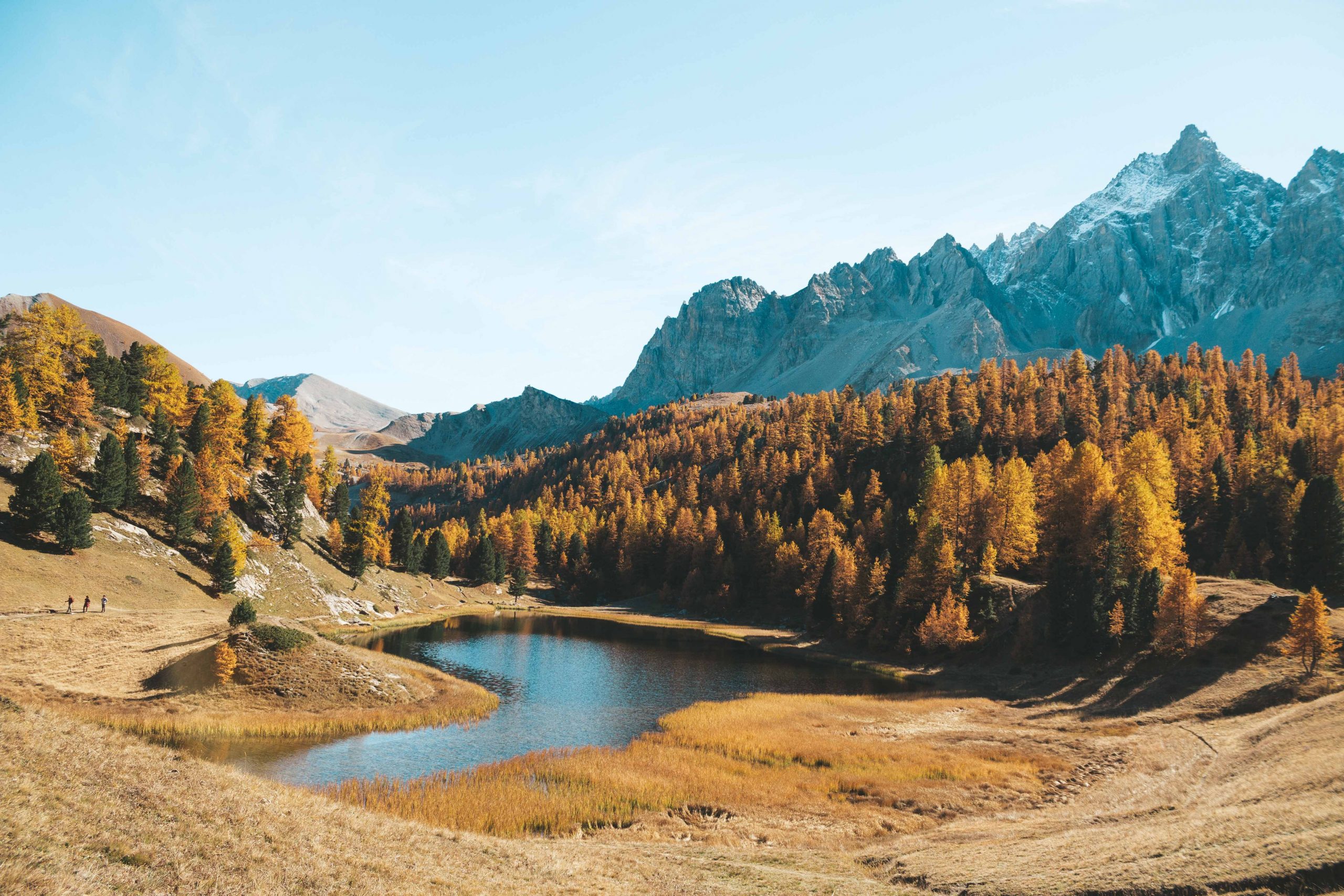 mountain lake surrounded by mountains and forests